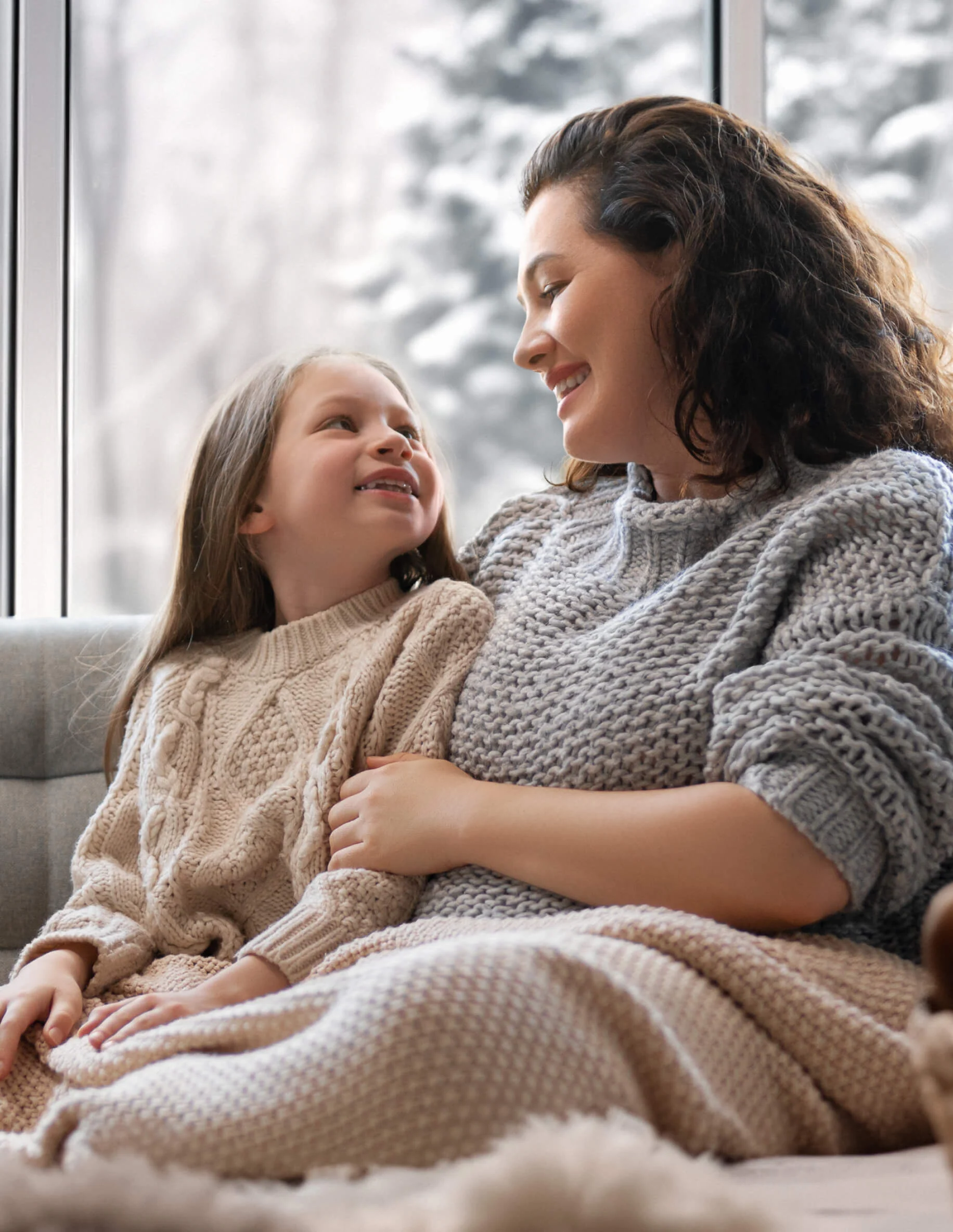 Mother and daughter sitting together warmly
